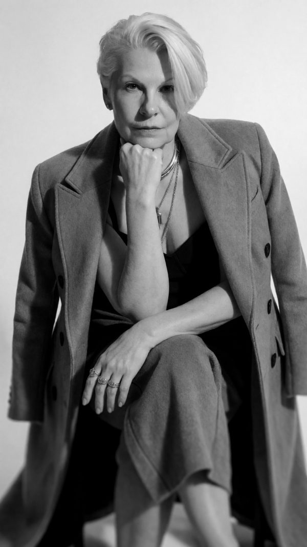 Julie Daly, founder of Bloody Marvellous - Bloody Marvellous Julie Daly, founder of Bloody Marvellous, in a black and white portrait, chin resting on her fist, looking straight at the camera.